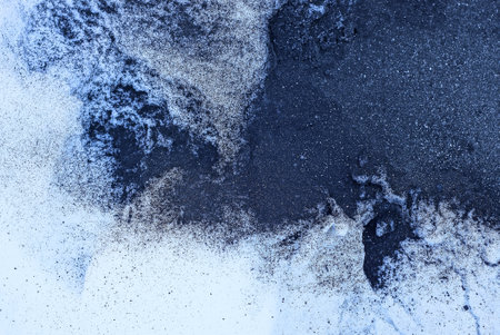 black and white texture from the ashes of a fire and snowの写真素材