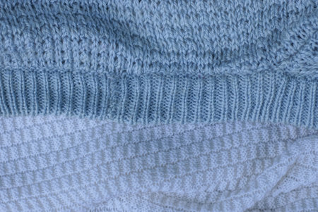 Gray white texture of a piece of crumpled cloth from clothes and seam