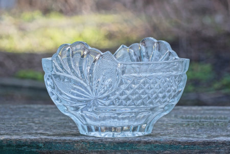 one white empty glass crystal salad bowl stands on a gray table in the streetの写真素材
