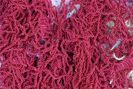 fabric texture from a pile of knitted thin red threads
