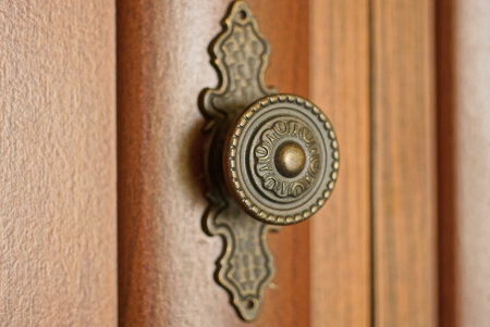 one old round brown wooden door handle on a wooden doorの写真素材