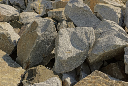 gray texture from pieces of large stones in a pile on the street
