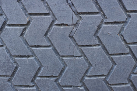 black gray plastic texture from an old dirty car tire with small cracksの写真素材