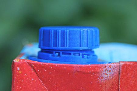a piece of red paper bag covered with blue plastic lidの写真素材