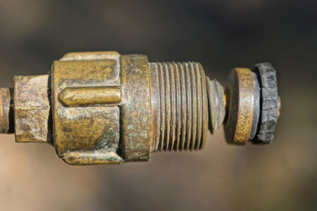part of one old brown copper tube with thread on gray backgroundの写真素材