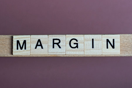 gray word margin made of wooden square letters on brown backgroundの写真素材