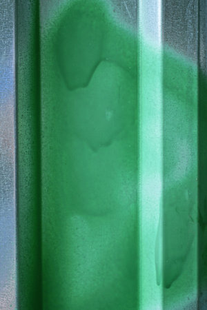 metal texture from gray iron wall with green paint stainの写真素材