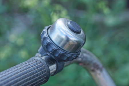 one black gray bicycle bell on the metal handlebar of a sports bike on the streetの写真素材