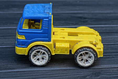 toy truck on a black wooden background. toy for children.