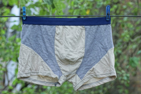 Men underwear hanging on the clothesline in the garden, stock photoの写真素材