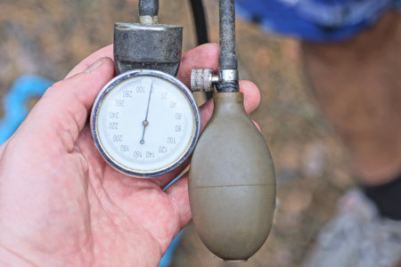 hand of one man holding medical tonometer pressure meter with rubber bulbの写真素材
