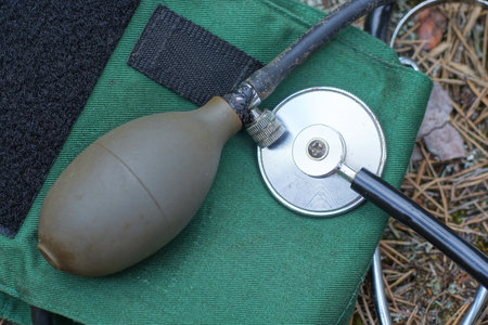 a set of medical instruments from a blood pressure monitor and a stethoscope with a tonometer lie on...