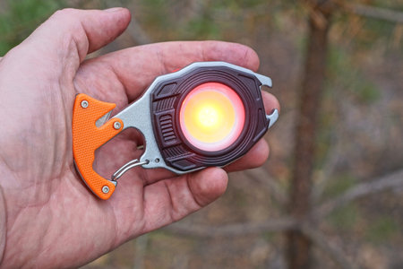 hand holding one small flashlight with red light
