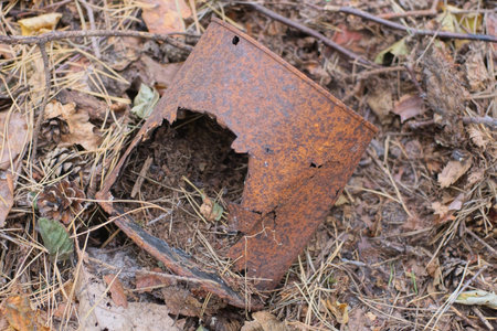 Abandoned rusty tin can on the ground in the forest.の写真素材