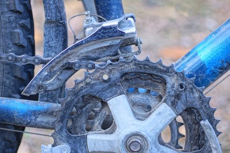 bicycle pedal on a metal sprocket with a chain on a blue sports bike on the street