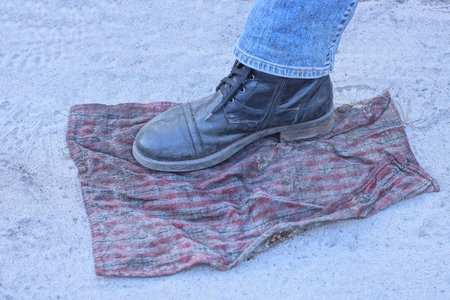 Shoes on a plaid on the beach, closeup of photo