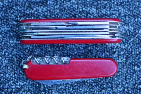 red and black multitool on a blue background, closeup of photoの写真素材