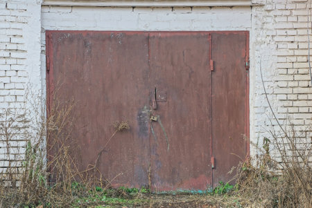 Old rusty metal door in an abandoned house. Abandoned house.の写真素材