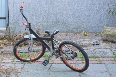 Bicycle in front of a gray wall in the city. Shallow depth of field.の写真素材