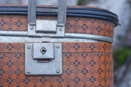 one gray open metal latch lock on brown leather old suitcaseの写真素材