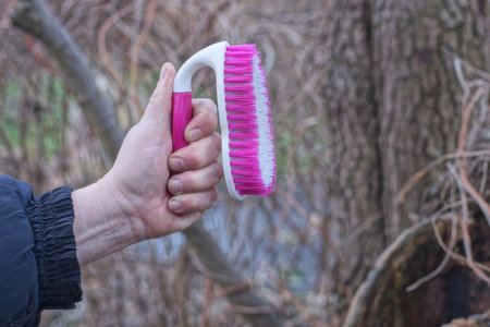 hand holding one plastic colored brushの写真素材