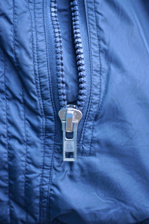 white open metallic zip on blue synthetic clothing fabric