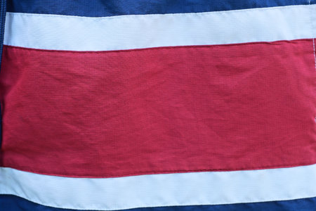 Red fabric texture with blue white stripe on clothes