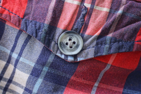 one gray button on colored fabric clothing with pocket