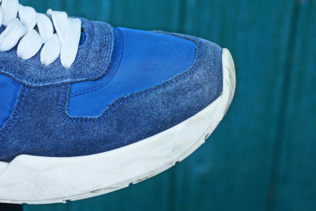 sock blue white sneaker made of fabric and suede on the summer street