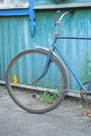 one retro bicycle on the background of a wooden wall of a rural house in the streetの写真素材