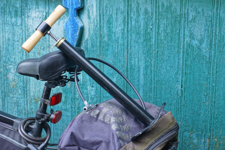 one black pump with hose lies on the bike rackの写真素材