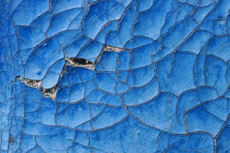 blue texture of old upholstery in the cracks with a torn hole in the liningの写真素材