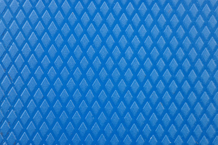 blue plastic texture from a piece of old wall with a patternの写真素材