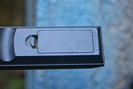 part on old black plastic remote control with closed battery pack on a blue backgroundの写真素材