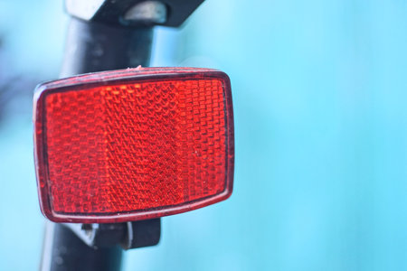 one red plastic warning light on a black blue sports bike in the street on a blue backgroundの写真素材