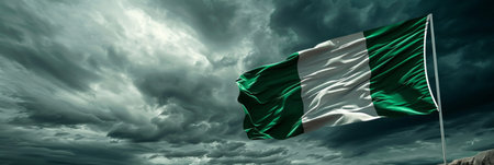 Nigerias flag waves bravely in the midst of a storm, symbolizing unity and strength against all odds.の素材