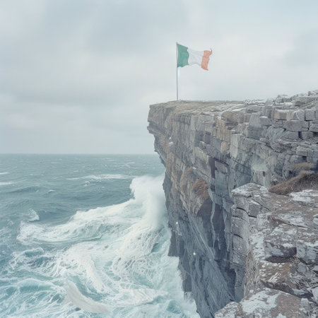 Irish flag billows in the wind over a rugged cliff in Ireland, symbolizing pride and patriotism against a stunning natural backdrop.の素材