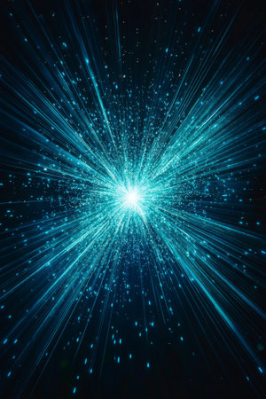 A vivid explosion of turquoise particles emits glowing dust, creating a mesmerizing display of cosmic energy as it spreads elegantly across the dark background.の素材
