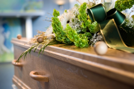 A coffin with a flower arrangement at a mortuaryの写真素材