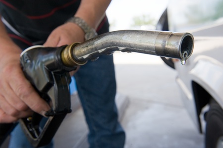 A drop of diesel fuel hanging on a fuel nozzleの写真素材