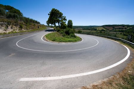 A hairpin bend on a road in the mountains of Toscany in Italy