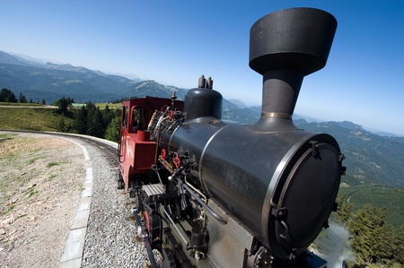 An old steam locomotive is climbing up the 'schafbergbahn' on to the top of the Schafberg (1783...