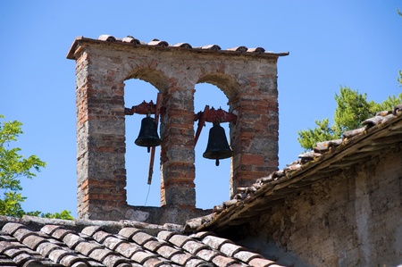 Two bells on the roof of a small church in Tuscany in Italy.の写真素材