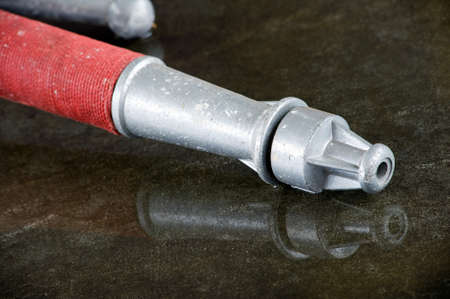 A nozzle on the wet floor in a firestation used by firefightersのeditorial素材