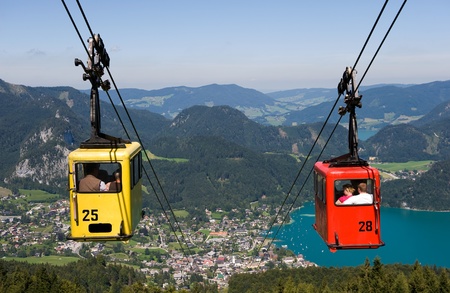 A cableway is bringing tourists up the zwolferhornmountain near the city of st Gilgen in Austriaの写真素材