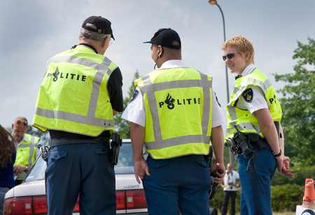 HAAKSBERGEN, NETHERLANDS - JUNE 09  Two policemen and a policewoman are talking with each other during a massive traffic control, june 09, 2011 in the Netherlandsのeditorial素材