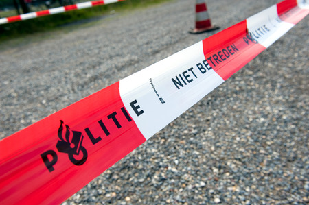 HAAKSBERGEN, NETHERLANDS - JUNE 09  Cordon tape from the dutch police is marking a crime scene and forbidden to pass, june 09, 2011 in the Netherlandsのeditorial素材