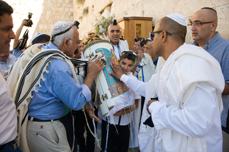 JERUSALEM, ISRAEL - OCT 06, 2014: Bar Mitzvah ritual at the Wailing wall in Jerusalem. A 13 years old boy who has become a Bar Mitzvah is morally and ethically responsible for his decisions and actionsのeditorial素材