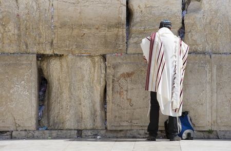 JERUSALEM, ISRAEL - OCT 07, 2014: A jewish man is praying in front of the western wall in the old...