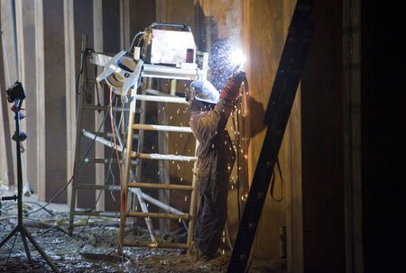 ENSCHEDE, THE NETHERLANDS - 27 OKT, 2014: Welder at work on a construction site